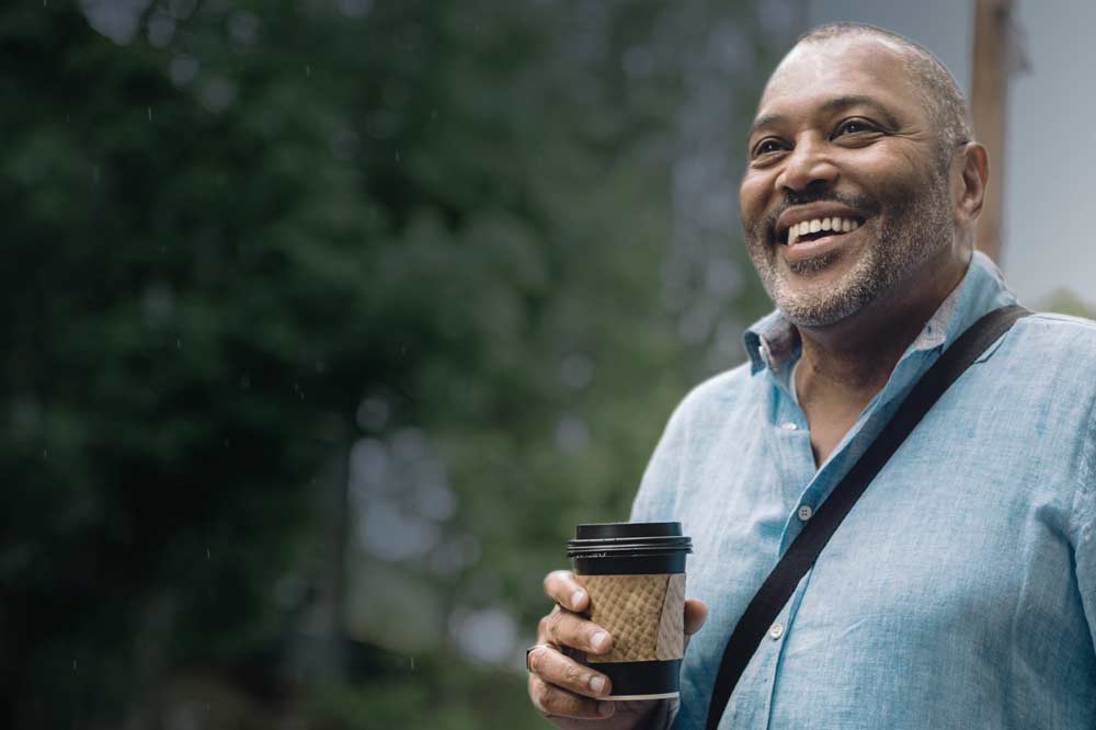 Man smiling with coffee